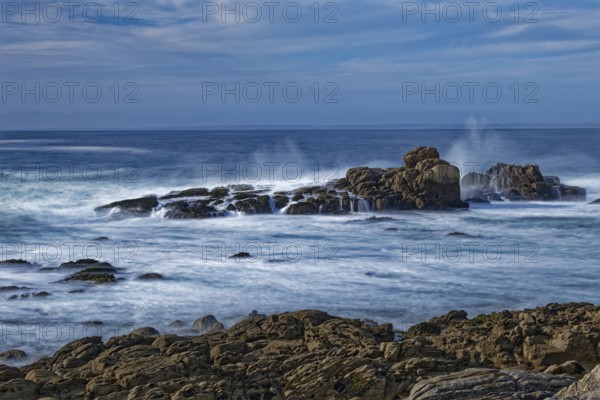 The waves of the Atlantic wash over the rocks on the coast off Penmarch in Brittany. Finistere,