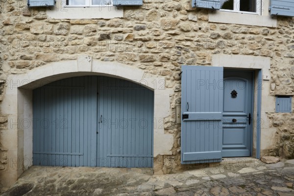 Door and gate on a house in La Roque-sur-Cèze, Département Gard, Occitanie region, France, Europe