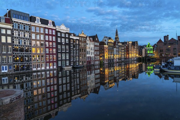 Canal houses on the Damrak, in the centre of the old town of Amsterdam, harbour, starting point of