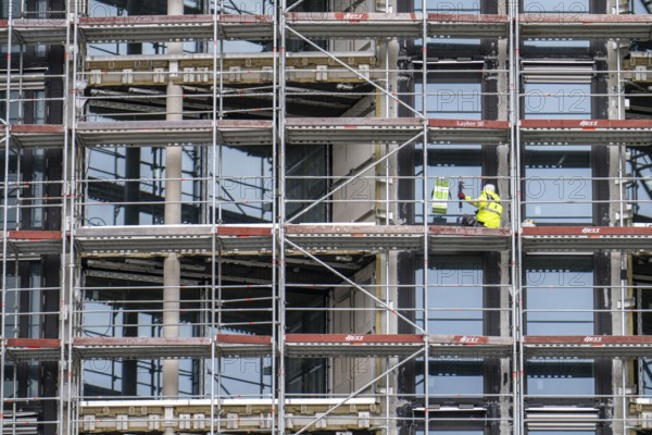 Large construction site, construction of a residential building with many flats, scaffolding,