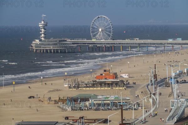 View over the beach of Scheveningen, the pier with Ferris wheel belongs to the city of The Hague