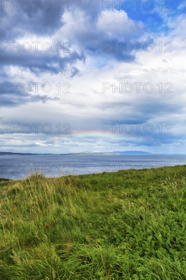 Rainbow over the sea, coastline between Ballycastle and Ballintoy, Carrick-a-Rede, Causeway Coastal