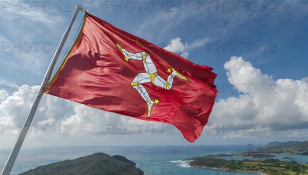 The flag of the Isle of Man, Great Britain, flutters in the wind