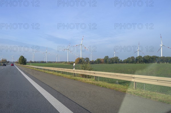 Wind turbines on the motorway. A9 motorway, Thuringia, Germany, Europe