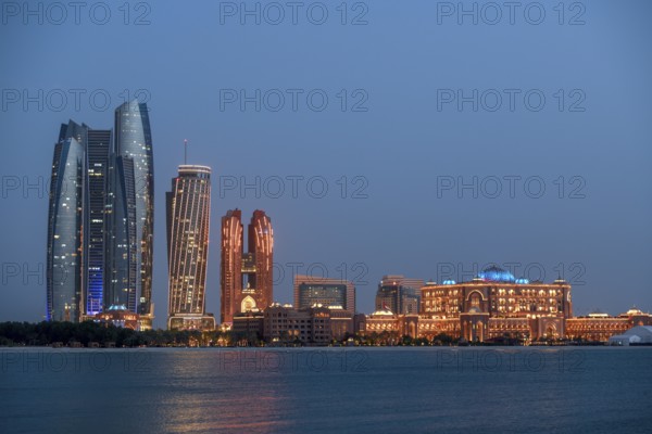 Skyline at dusk, Etihad Towers and Emirates Palace Hotel, Abu Dhabi, Emirate of Abu Dhabi, United