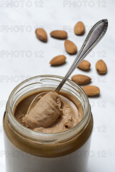Almond cream in jar with spoon, almond spread
