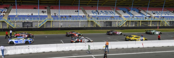 Panoramic photo of part of grid lane with starting grid of racing cars sports cars of GT4 class of