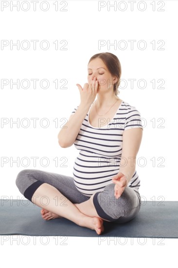 Pregnancy yoga exercise, pregnant woman doing yoga breathing exercise Pranayama isolated on white
