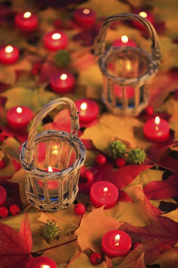 Burning candles, lit candles, different metallic colours