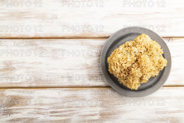 Raw Sparassis (Cauliflower Mushroom) on white wooden background. Top view, flat lay, copy space