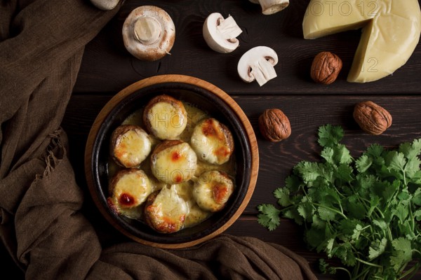 Traditional Georgian dish, appetizer, stuffed mushrooms, Sulguni cheese, baked in a Ketzi clay pan,