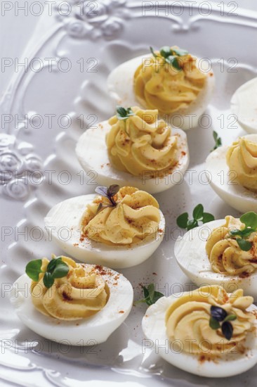 Boiled eggs stuffed with yolk with mayonnaise, on a white plate, selective focus, blurry, close-up,