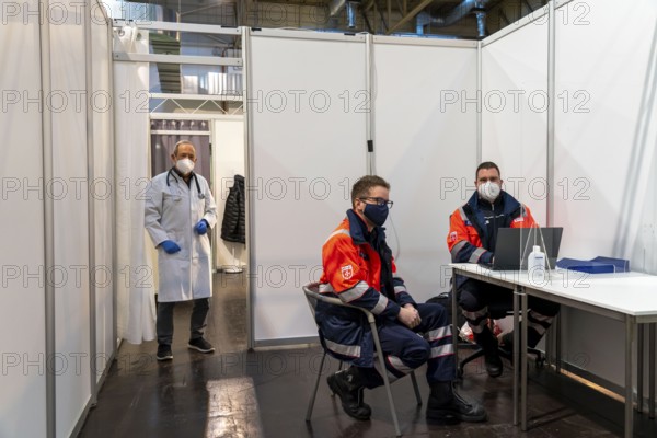Vaccination team, vaccination doctor and helpers at the test run in the vaccination centre for the
