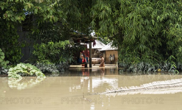 Morigaon, India. 4 July 2024. Residents in their flooded house, in a flood affected village in