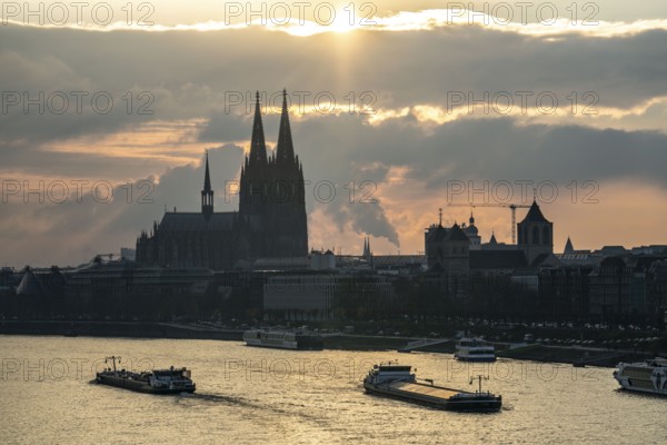 The Rhine near Cologne, sunset, Cologne Cathedral, cargo ship, North Rhine-Westphalia, Germany,