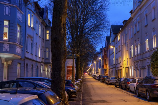 Residential street, many apartment buildings in a residential neighbourhood, evening, lantern