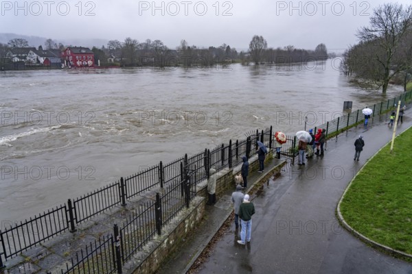 Spectators at high water on the Ruhr, here near Essen-Kettwig, below the weir of the Ruhr reservoir