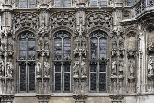 Historic town hall Stadhuis, partial view of the façade in Flamboyant Gothic style with sculptures,