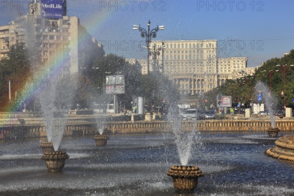 City centre, fountains and skyscrapers at Bulevardul Unirii, behind the Palace of Parliament,