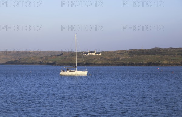 Yacht and farmhouse on Ringarogy Island from Baltimore, Roaringwater Bay, County Cork, Ireland,