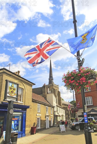 Flags frame view of spire St Peter and St Mary church in town centre, Stowmarket, Suffolk, England,
