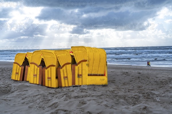 End of the season on the beach, dark storm clouds, choppy sea, autumn on the North Sea in North