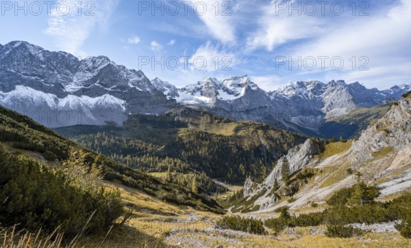 Mountain panorama with steep rocky peaks, yellow-coloured larches in autumn, view of Laliderspitze,