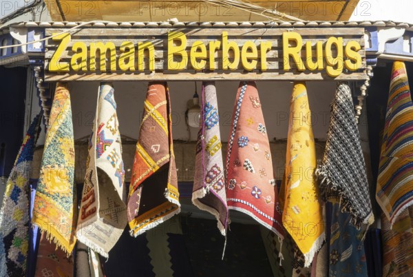 Traditional Berber rugs hanging on display outside shop in medina area of Essaouira, Morocco, north