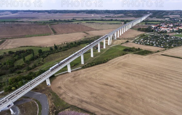 An aerial photo shows an ICE train travelling over the Unstruttal bridge near Karsdorf. The