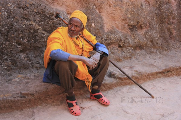 Rock churches of Lalibela, pilgrim sitting in front of a rock church, Ethiopia, Africa