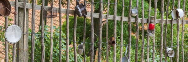 Traditional wooden fence, farm fence, decorated with old pots and utensils, rural idyll, country