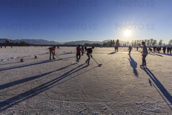 People playing ice hockey on a lake, evening light, sunbeams, Staffelsee, Murnau, foothills of the