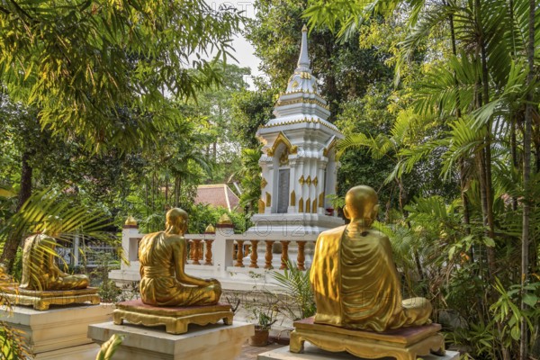 Golden statues of monks in the garden of the Buddhist temple complex Wat Phra Singh, Chiang Mai,