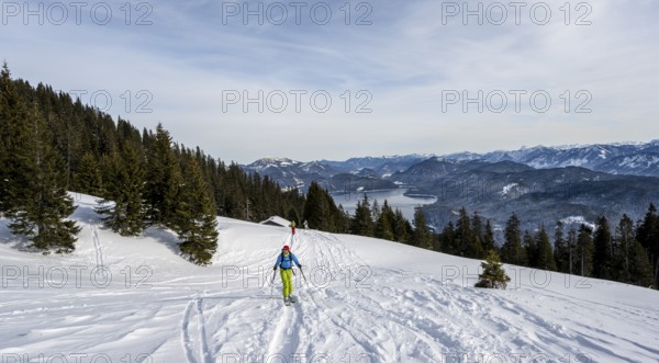 Ski tourers climbing Simetsberg, view of Walchensee, Estergebirge, Bavarian Prealps, Bavaria