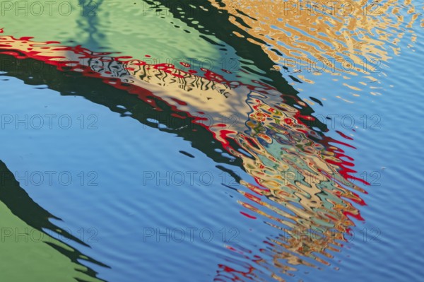 Traditional Moliceiro boat reflected in the water, Aveiro, Portugal, Europe