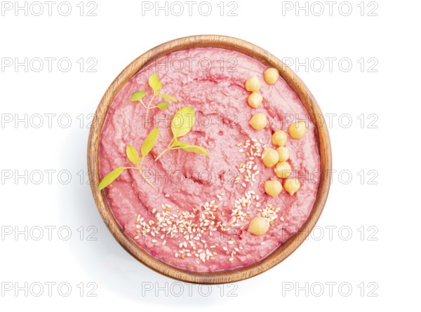Hummus with beet in wooden bowl isolated on white background. Top view, flat lay, close up