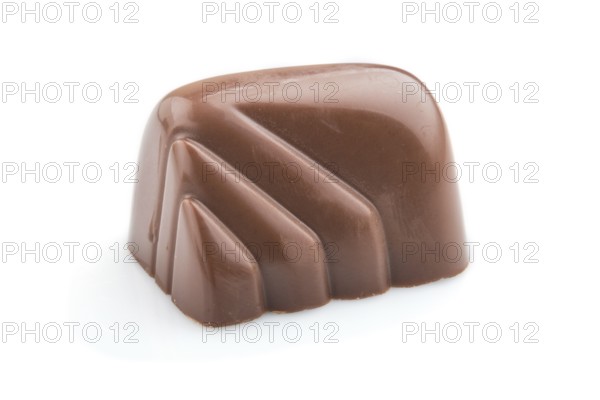 Single chocolate candy isolated on white background. side view, close up
