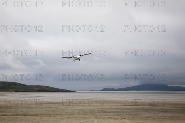 Flybe plane taking off from sandy airstrip Isle of Barra airport, Barra, Outer Hebrides, Scotland,