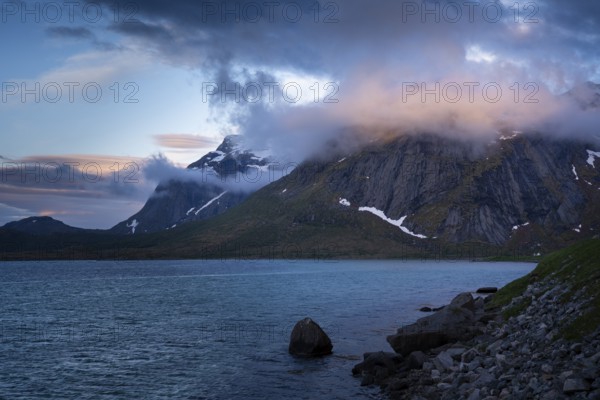 Mountain landscape on the Lofoten Islands. View over the sea to a mountain, the summit is in the