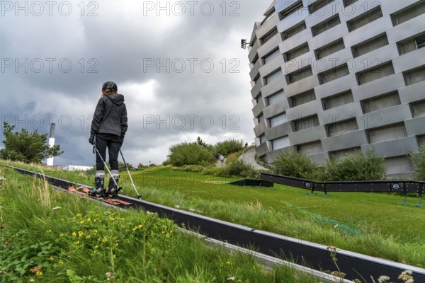 CopenHill, waste incineration plant and artificial ski slope, skiing with a view of the ski lift,