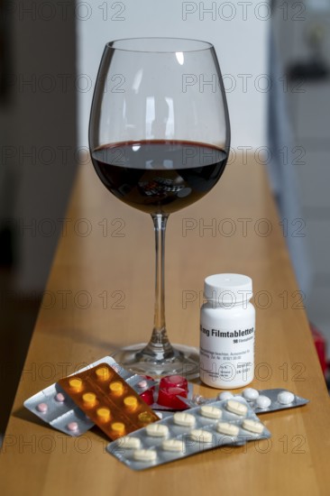 Symbolic image of alcohol and medication, you should not take medicine, pills, tablets with