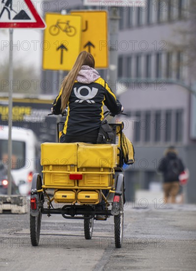 Deutsche Post delivery woman on an electric post tricycle
