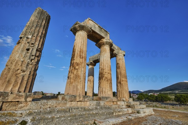 Archaic Temple of Apollo, Doric columns, Sun illuminates ancient stone columns and ruins of a