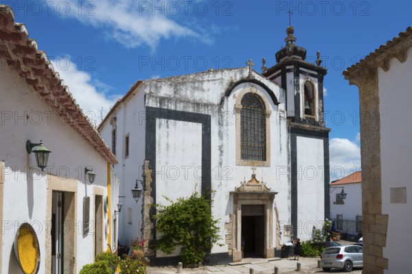 Baroque church with magnificent bell tower and blue sky, Church Igreja de São Pedro, Óbidos,