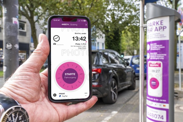 Parking in public spaces via parking app, EasyPark, here in Bochum, parking ticket machine where