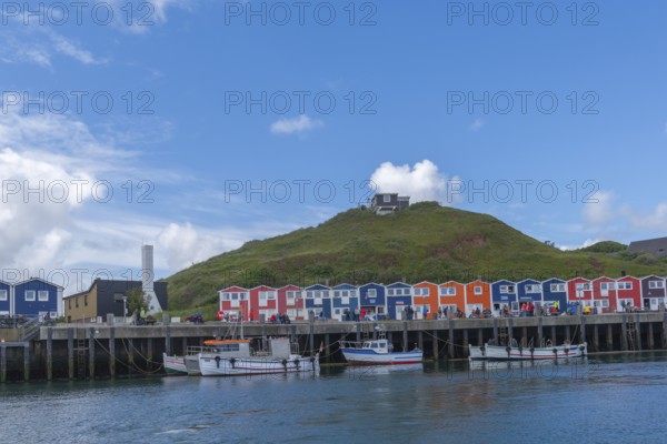 Colourful lobster shacks on the harbour promenade, Börteboote, offshore island Helgoland, blue sky,