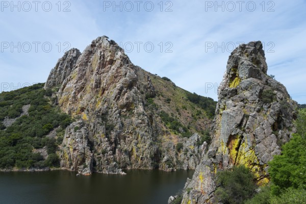 Spectacular rock formations above a river, embedded in hilly nature, Salto del Gitano, River Tagus,
