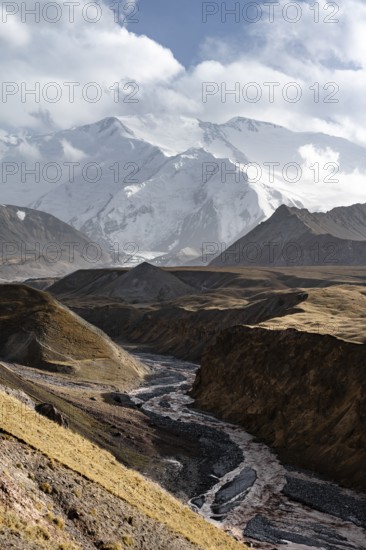 Achik Tash river, Achik Tash valley, behind glaciated and snow-covered mountain peak Pik Lenin,