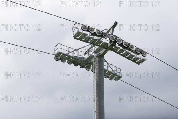 A cable car support with steel cables in a cloudy sky, Jennerbahn am Königsee, Königsee,
