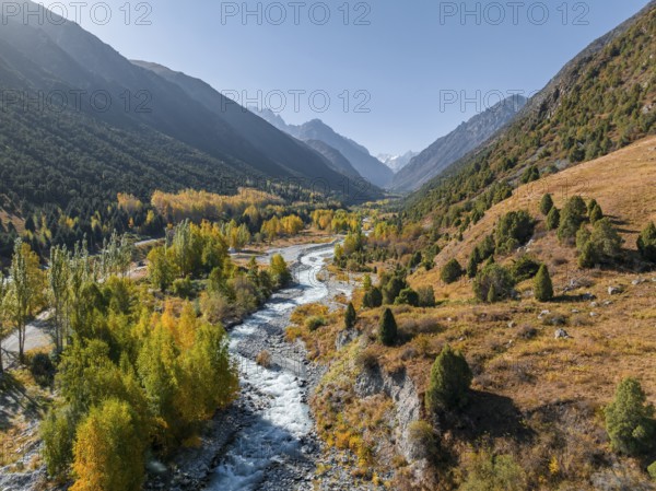 Aerial view, mountain stream Ala Archa flows through the Ala Archa valley, autumnal mountain